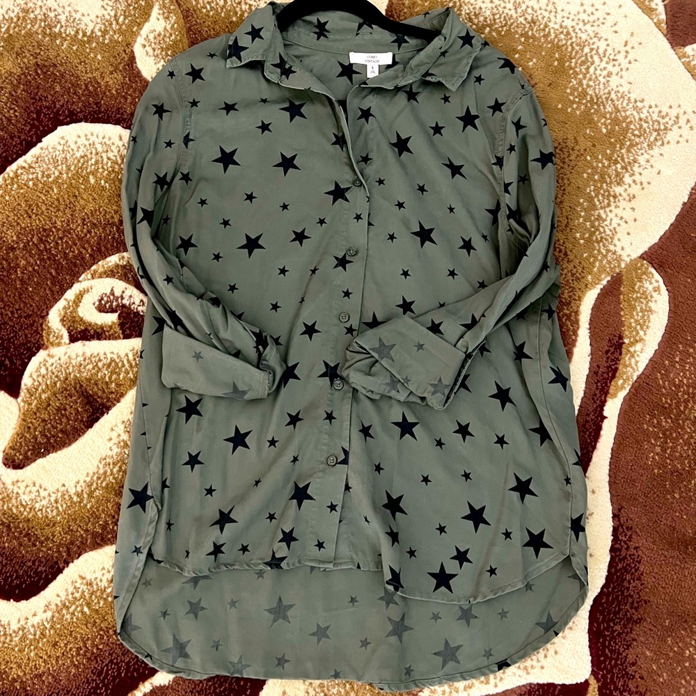 Gently used blouse, dark green colors with stars.